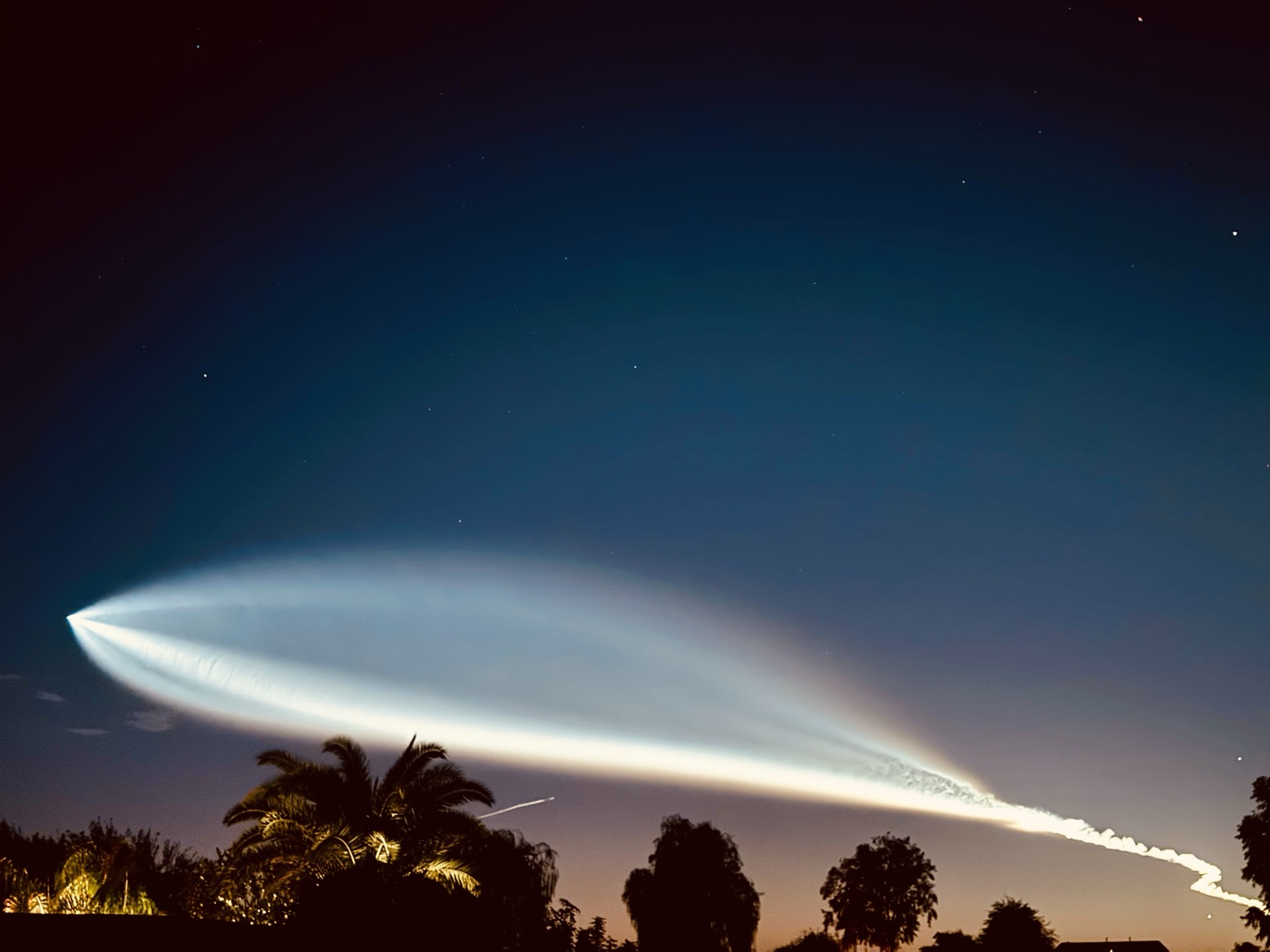 A luminous rocket plume crossing the Arizona night sky